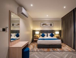 a bedroom with a large bed and a mirror at Garden Melenium - Jeddah in Jeddah +18 photos
