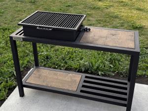 a black picnic table with a grill on top at Дом с бассейном и мангальной зоной in Ustʼ-Kamenogorsk