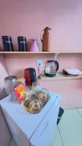 a shelf with a tray of dishes on a table at Quarto próximo ao parque de exposição BR163 in Dourados +6 photos