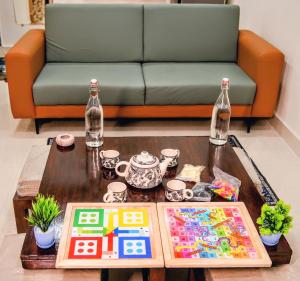 a living room with a couch and a coffee table at 1 BHK by Agartha Atithya in Hyderabad