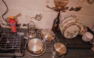 a counter with plates and dishes on a rack at 1 BHK by Agartha Atithya in Hyderabad +21 photos