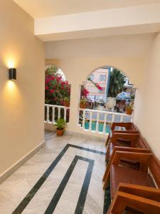a row of benches in a room with windows at Evergreen Bungalows in Dwarka