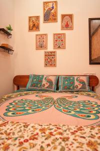 a bedroom with a bed with a colorful bedspread at 1 BHK by Agartha Atithya in Hyderabad