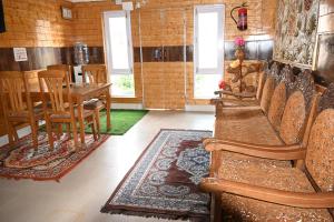a room with chairs and a table and a dining room at Himalayan Cottages Pahalgam in Pahalgām