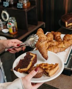 a person is eating a plate of food with bread at Cavour 19 - Dependance in Torre dell'Orso