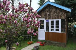 a small shed with a white door and a tree at Himalayan Cottages Pahalgam in Pahalgām
