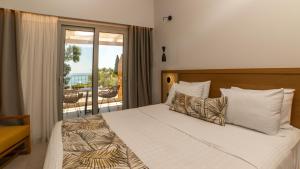 a bedroom with a large bed and a balcony at Eterrano Seaside Retreat in Parga +190 photos