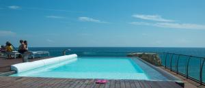 a swimming pool on the deck of a resort at Cavour 19 - Dependance in Torre dell'Orso