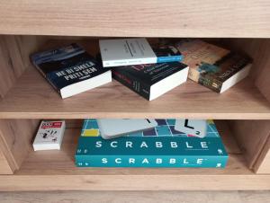 a group of books on a book shelf at Vinea Apartma in Gornja Radgona
