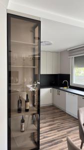 a kitchen with a glass cabinet with wine glasses at Vila Manuela in Gevgelija