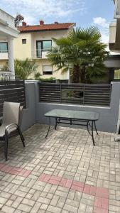 a bench sitting on a patio in front of a building at Vila Manuela in Gevgelija