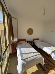 a room with two beds in a room at Dana Village lodge and Camp-Wadi Dana Eco camp in Dana