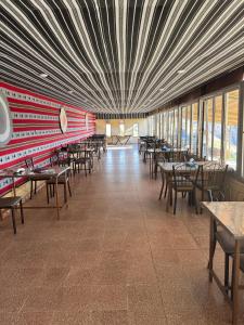 an empty dining room with tables and chairs at Dana Village lodge and Camp-Wadi Dana Eco camp in Dana