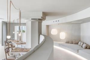 a living room with a couch and a dining room at Gran Hotel Suances Suites in Suances