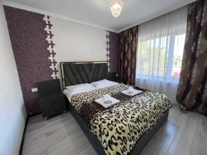 a bedroom with a bed with two towels on it at Ala-Too Hotel in Naryn