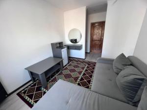 a living room with a couch and a table at Ala-Too Hotel in Naryn +29 photos