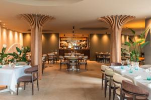 a restaurant with tables and chairs and a bar at Hotel Olivier in Split
