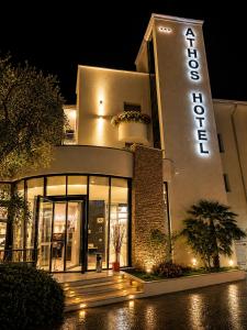 a building with a sign on it at night at Athos Hotel in Riva del Garda