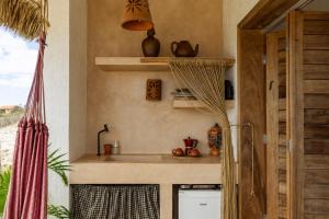 a kitchen with a sink in a room at Yvytu - Ohana Bungalow in Tatajuba