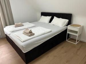 a bedroom with a bed with two towels on it at Premium Apart Villa Hamburg in Hamburg
