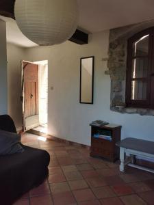 a living room with a couch and a table and a window at Maison de village, Verdon in Trigance