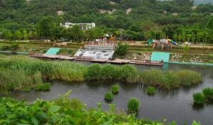 a body of water with a park with a playground at Buan Mul Love Pension in Buan