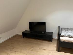 a living room with a flat screen tv and a couch at Premium Apart Villa Hamburg in Hamburg