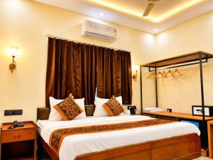a hotel room with a large bed and a window at Hotel CozyKey Rajpur Road in Dehradun