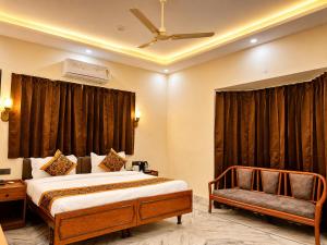a hotel room with a bed and a couch at Hotel CozyKey Rajpur Road in Dehradun +14 photos