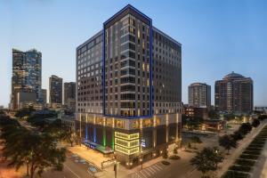 a rendering of a tall building in a city at Holiday Inn Express Houston Downtown by IHG in Houston