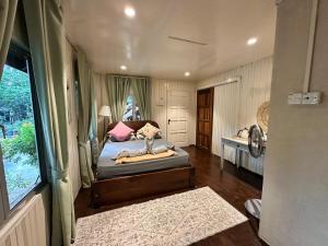 a bedroom with a bed and a window at Rumah D'Rhu, Zaki's Residence in Marang