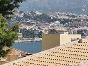 a view of a city with a body of water at Azul Rentals Albir flat by Lighthouse in Albir +4 photos