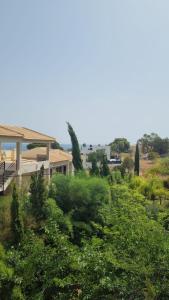 a view of a house with trees and bushes at Azul Rentals Albir flat by Lighthouse in Albir