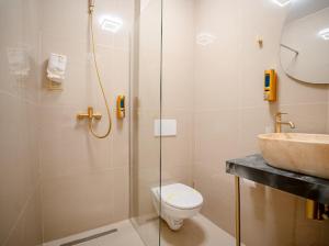 a bathroom with a shower and a toilet and a sink at Luna Boutique in Bucharest +90 photos