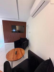 a living room with a table and a couch at אחוזת תכשיט in Sifsufa