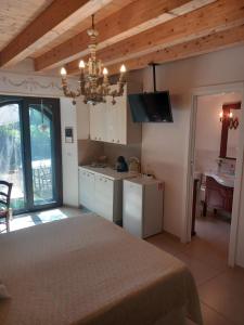 a kitchen with a table and a chandelier at Riccioli dell' Etna in Piedimonte Etneo
