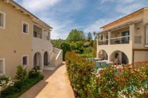an external view of a villa with a garden at Eterrano Seaside Retreat in Parga