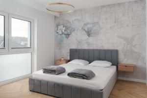 a bedroom with a bed with two pillows on it at Ciche Tarasy in Stężyca