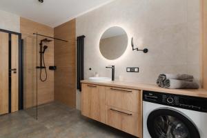 a bathroom with a washing machine and a sink at Ciche Tarasy in Stężyca +14 photos