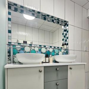 a bathroom with two sinks and a mirror at Aandster in Paternoster +18 photos