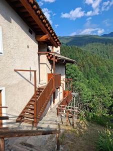 a house with wooden stairs on the side of it at Reinero Terrazza in Marmora