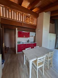 a kitchen with a table and chairs in a room at Reinero Terrazza in Marmora
