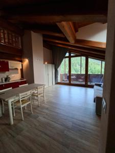 a large living room with a table and chairs at Reinero Terrazza in Marmora