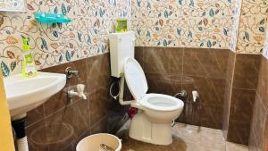 a bathroom with a toilet and a sink at New royal dormitory in Raipur