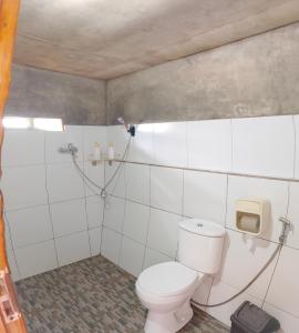 a bathroom with a toilet and a shower at Senaru sunset house in Senaru