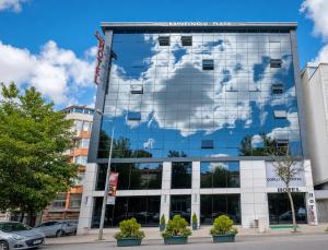 a building with a reflection of the world in the windows at Çorlu Dem Hotel in Çorlu