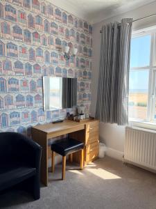 an office with a desk and a chair and a window at Imperial Lodge in Great Yarmouth