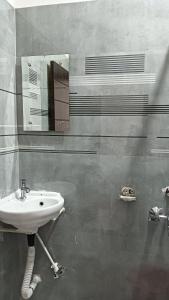a bathroom with a sink and a mirror at Hotel Janki Inn in Deoghar