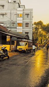 a yellow truck parked in front of a building at Hotel Janki Inn in Deoghar +5 photos