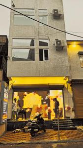 a motorcycle parked in front of a building with umbrellas at Hotel Janki Inn in Deoghar